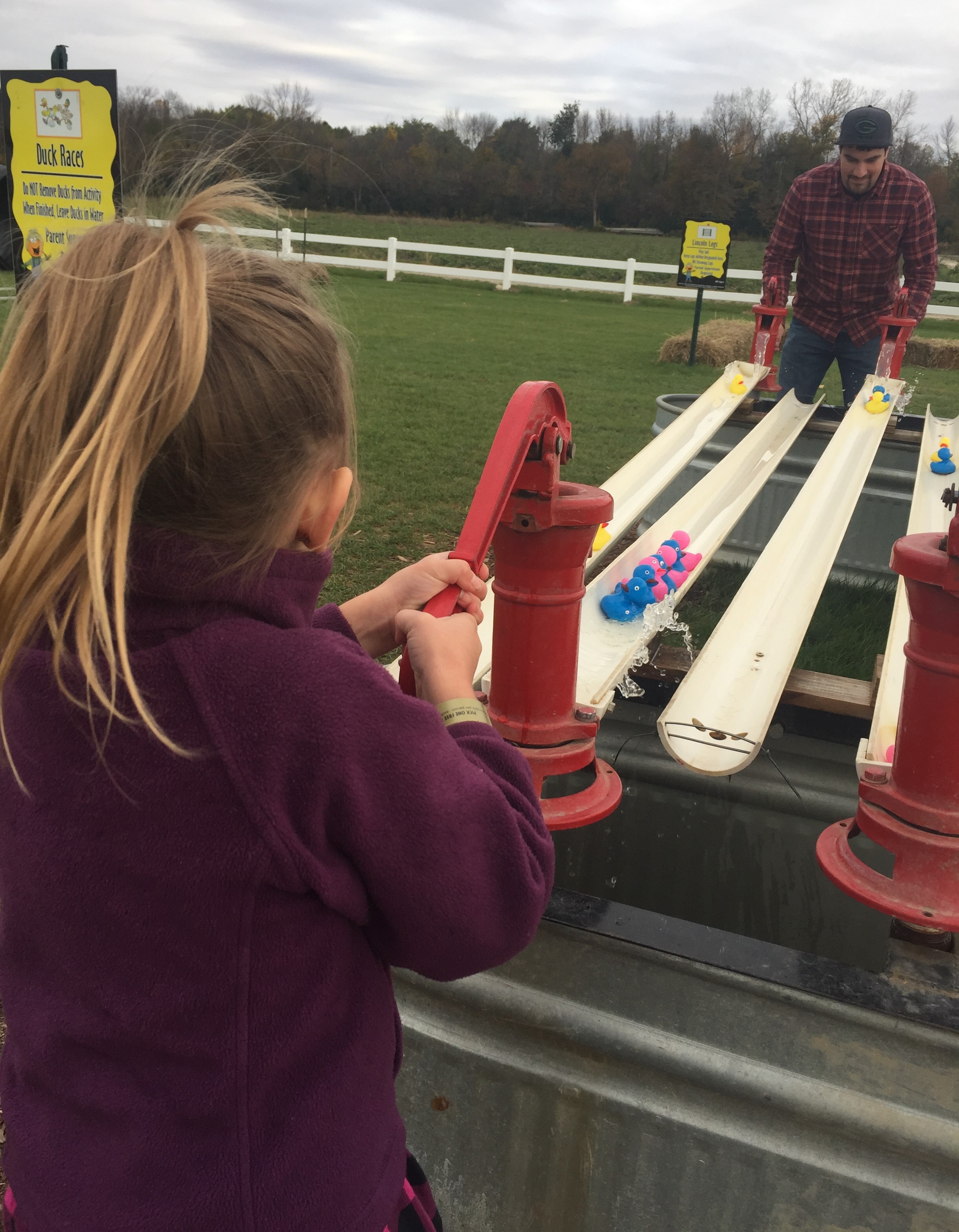 Daniel and Emma racing ducks with pvc and water
