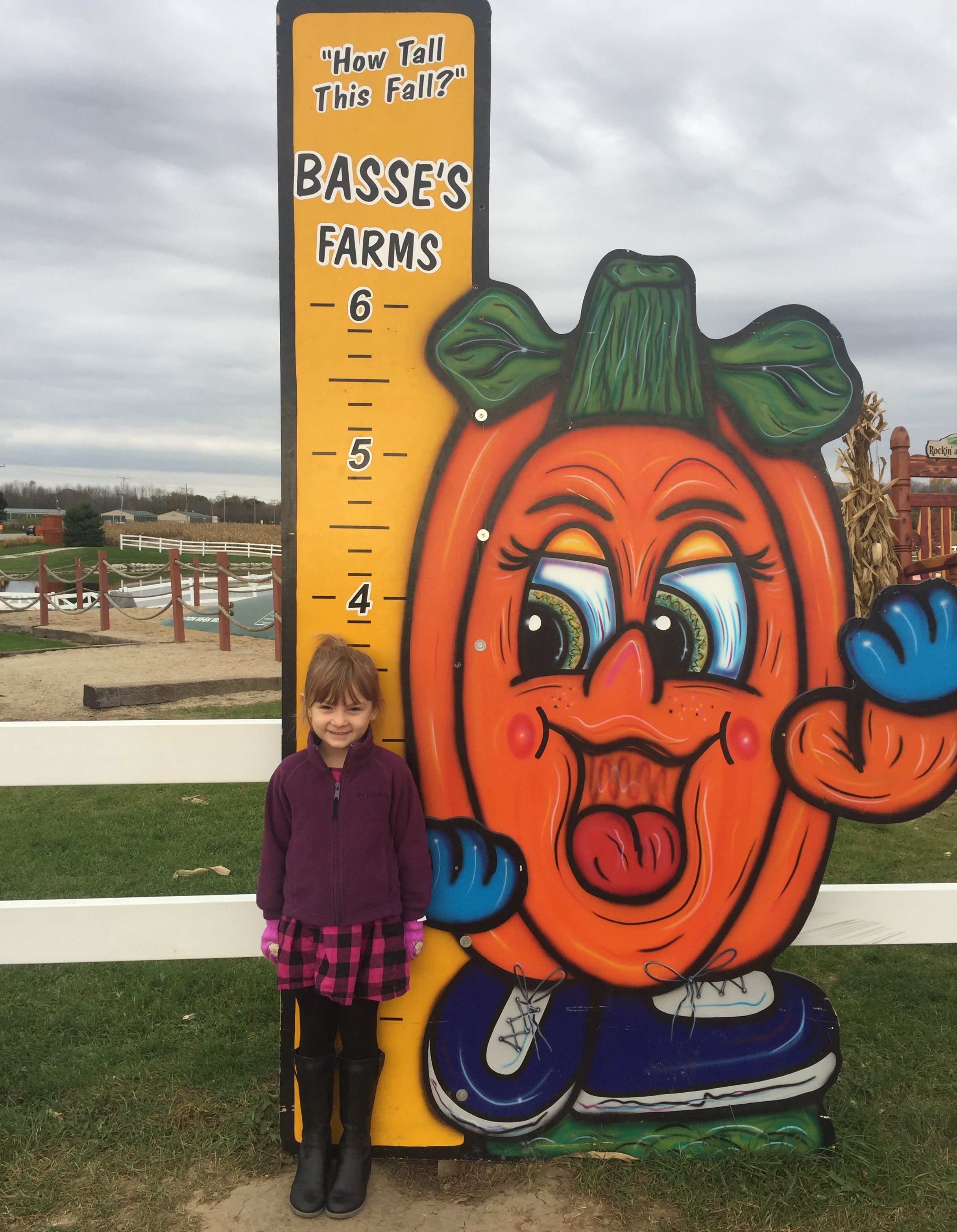 Emma standing next to heigh indicator