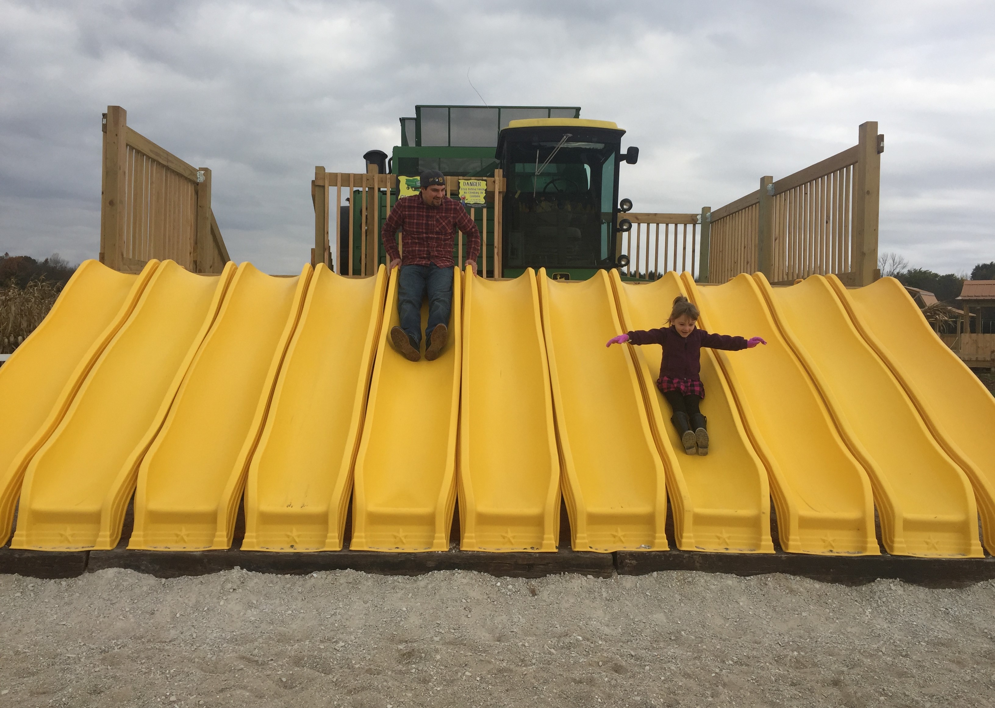 Daniel and Emma sliding down slide